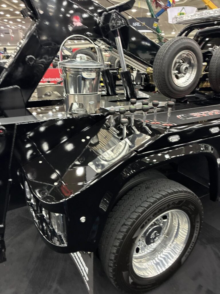close up of the back end of the black tow truck where the controls and storage are at the american towman show in baltimore