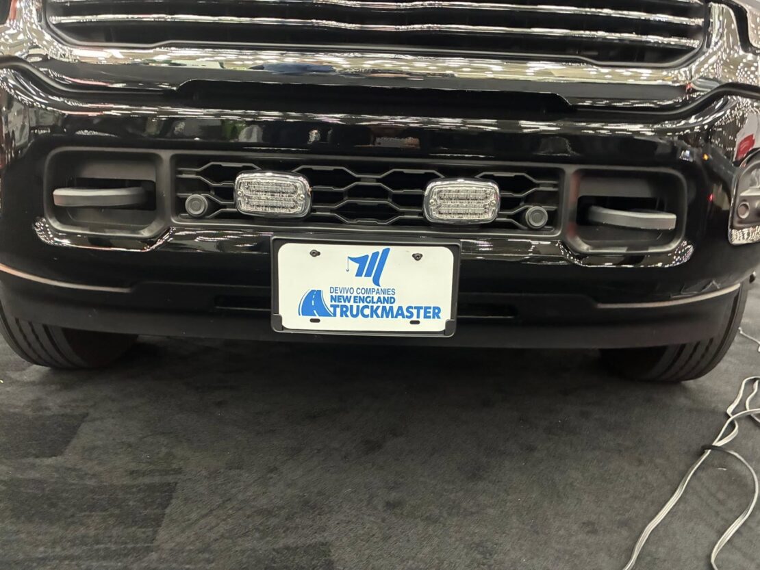close up of the license plate with the new england truckmaster on our black tow truck at the baltimore tow show