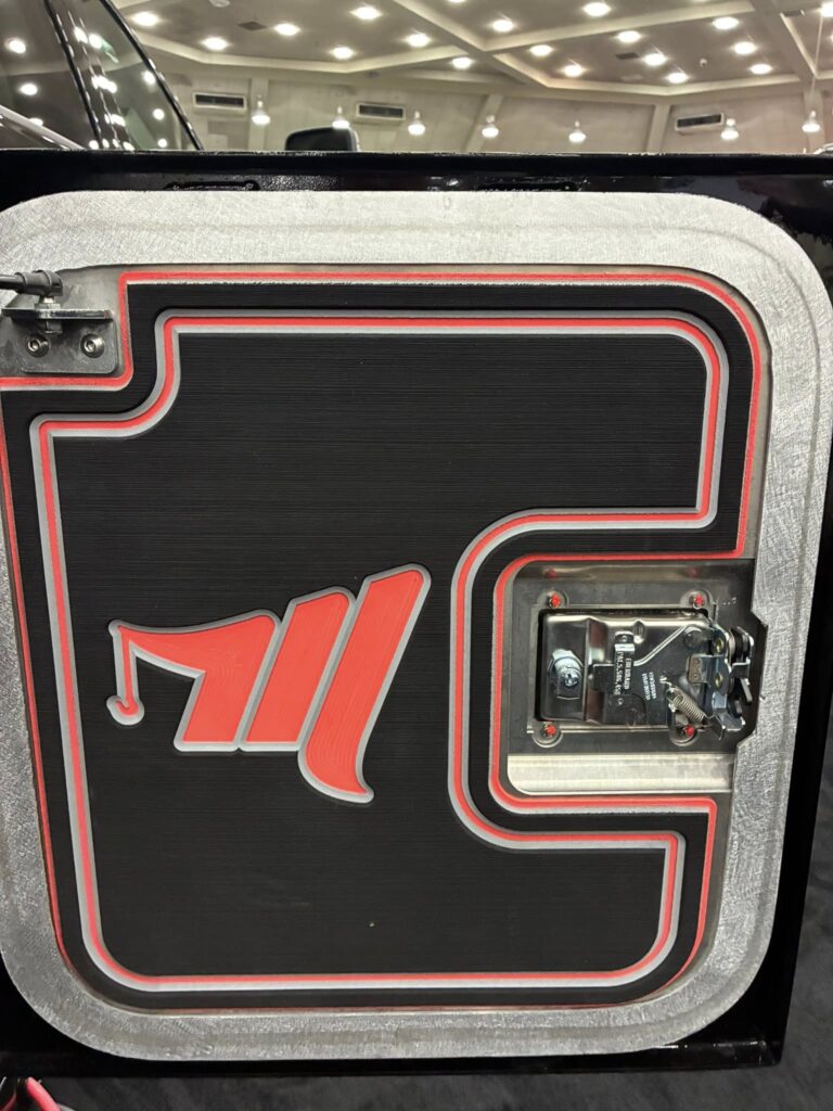 close up of the miller branded storage box on the back of the black tow truck at the american towman show in baltimore