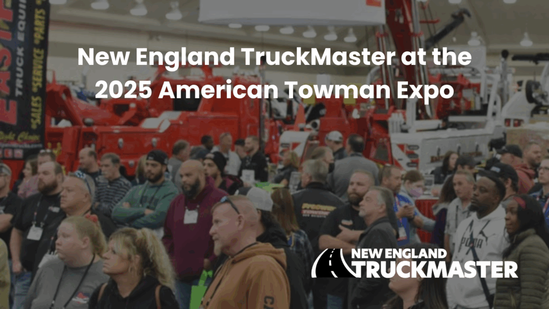 A group of people listening to a seminar with tow trucks in the background at the Baltimore Tow Show